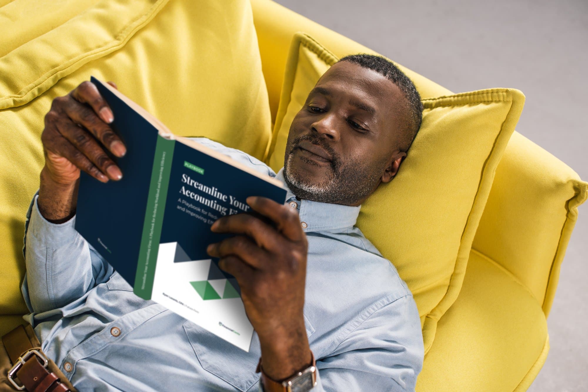 A man reading the playbook 'Streamline Your Accounting Firm: A Playbook for Reducing Workload and Improving Efficiency'