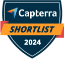 A blue shield-shaped badge with the Capterra logo and text that reads Capterra SHORTLIST 2024 in white and orange—perfect for showcasing your solution as a top taxdome alternative.