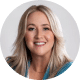 Headshot of a smiling woman with long blonde hair wearing a teal top against a light background.